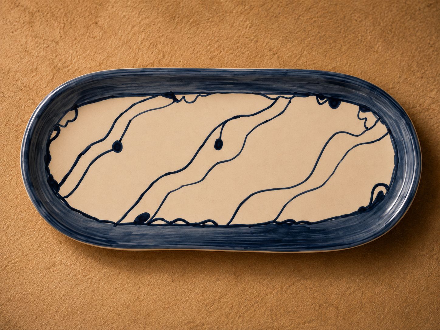 Handmade ceramic tray by Greek artist Aglaia Leoussi, decorated with blue abstract lines and organic shapes on white ceramic