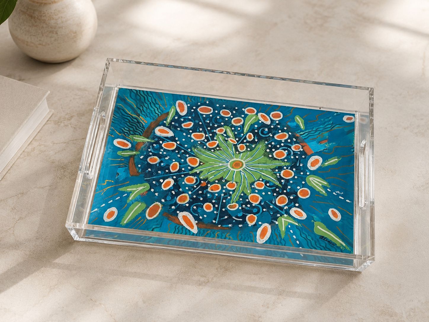 Decorative acrylic tray by Greek artist Aglaia Leoussi, featuring a vibrant blue floral artwork with orange, green, and white details