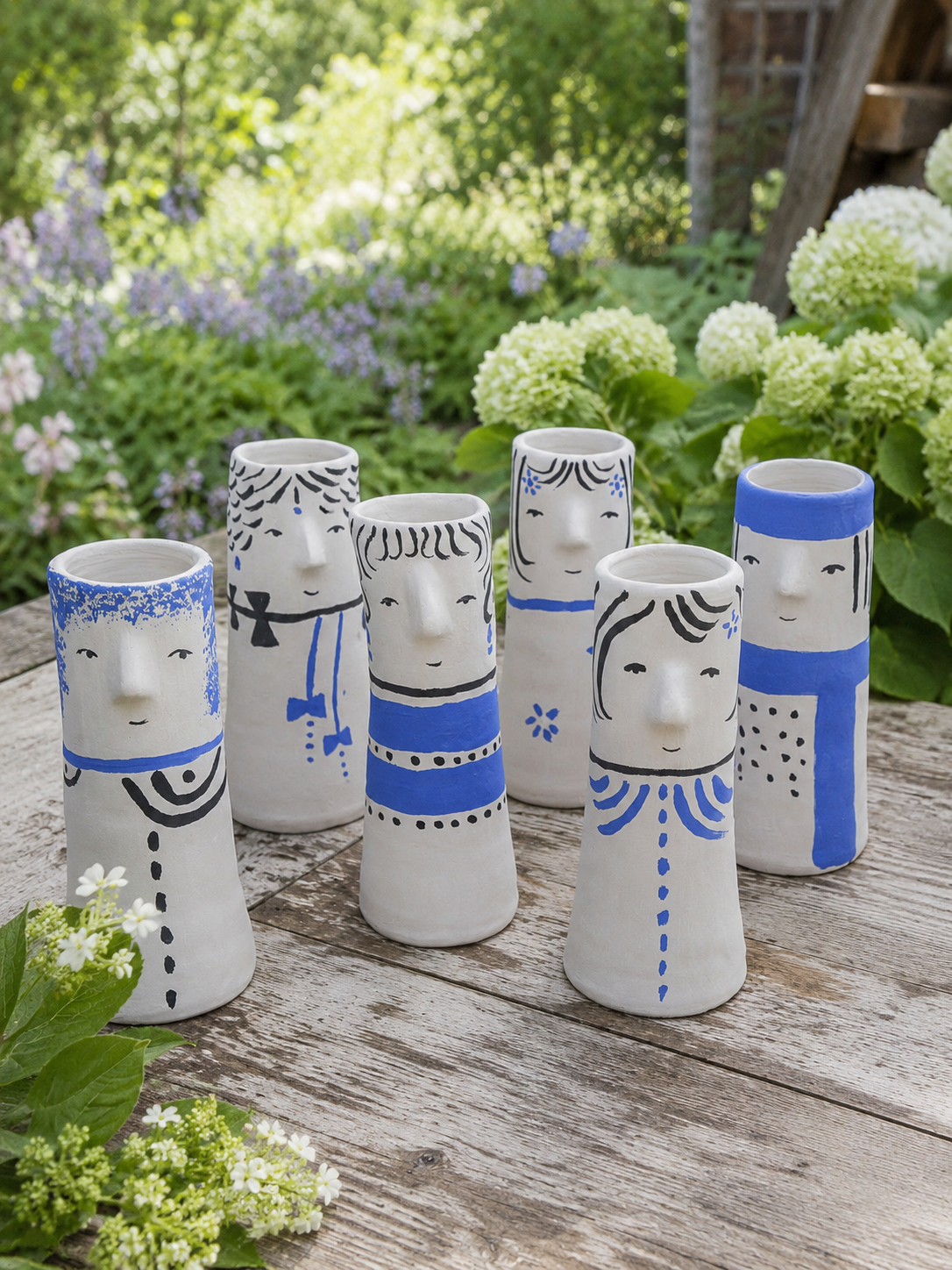 Faces Vases by Aglaia Leoussi / Αγλαΐα Λεούση, small hand-painted ceramic vases decorated with blue and black expressive face details
