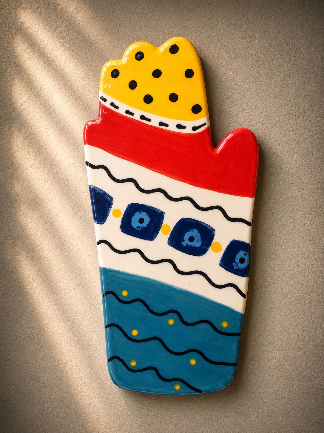 Happy Hands ceramic artwork by Greek artist Aglaia Leoussi, featuring a colorful hand-shaped sculpture with abstract painted patterns