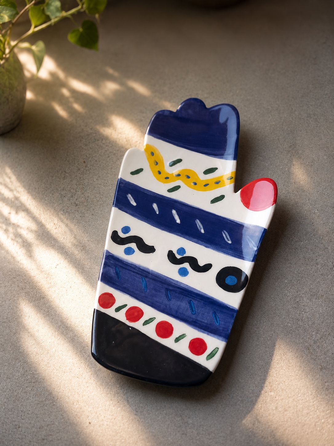 Happy Hands ceramic artwork by Greek artist Aglaia Leoussi, featuring a colorful hand-shaped sculpture with abstract painted patterns
