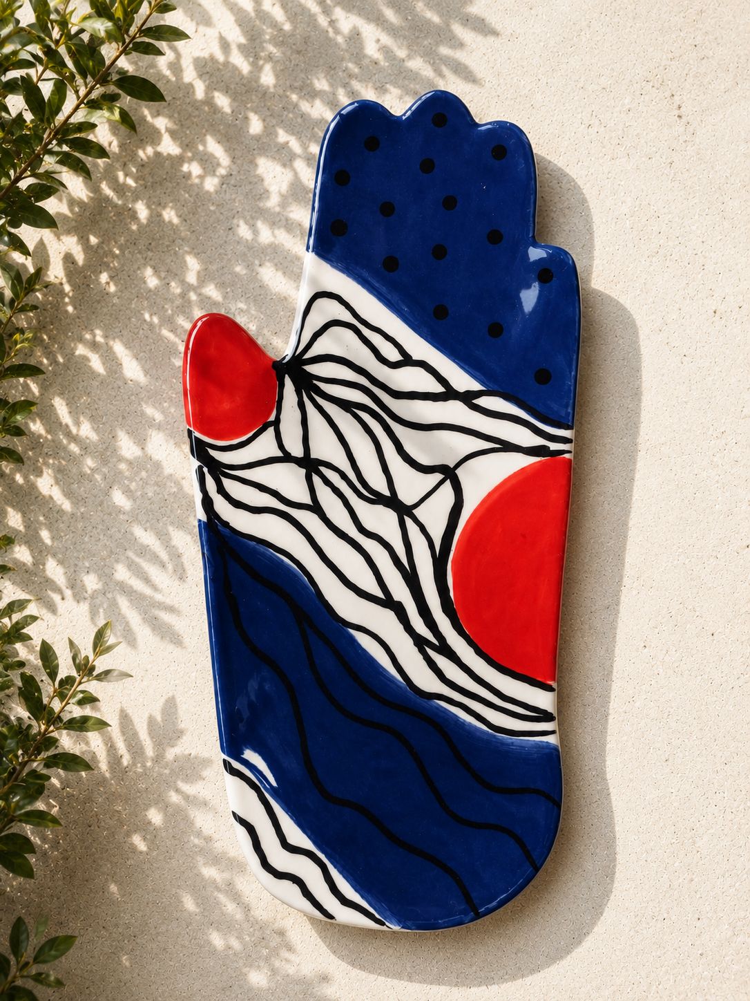 Happy Hands ceramic artwork by Greek artist Aglaia Leoussi, featuring a colorful hand-shaped sculpture with abstract painted patterns