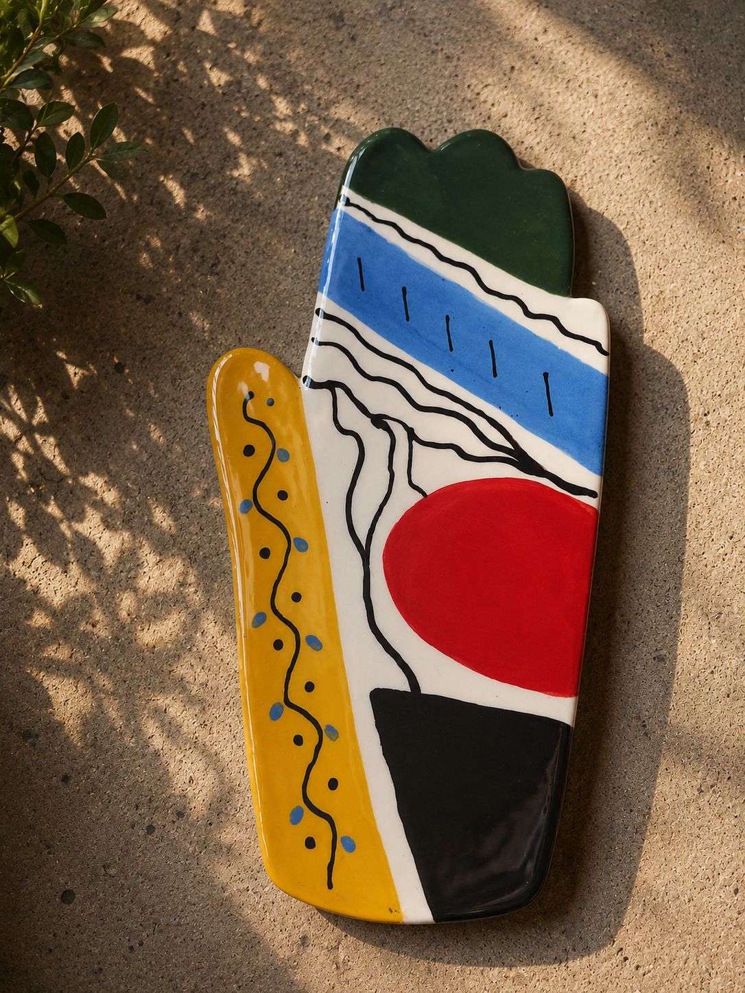 Happy Hands ceramic artwork by Greek artist Aglaia Leoussi, featuring a colorful hand-shaped sculpture with abstract painted patterns