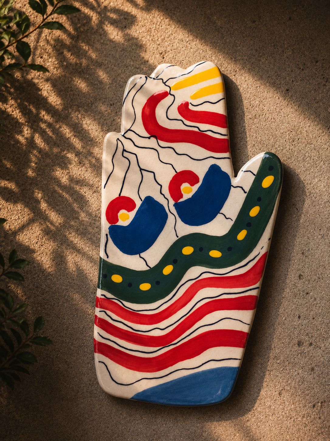 Happy Hands ceramic artwork by Greek artist Aglaia Leoussi, featuring a colorful hand-shaped sculpture with abstract painted patterns