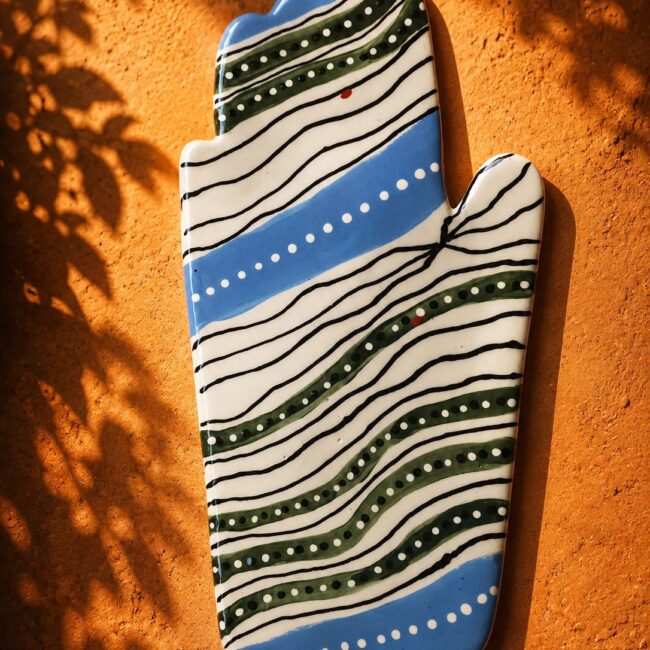 Happy Hands ceramic artwork by Greek artist Aglaia Leoussi, featuring a colorful hand-shaped sculpture with abstract painted patterns