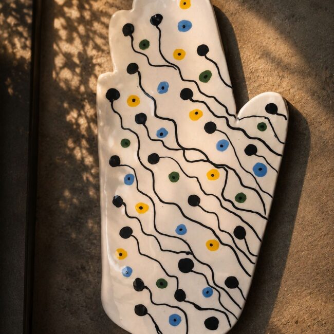 Happy Hands ceramic artwork by Greek artist Aglaia Leoussi, featuring a colorful hand-shaped sculpture with abstract painted patterns