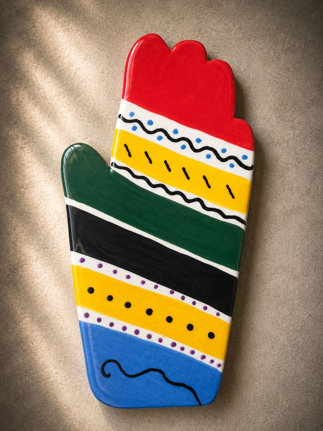 Happy Hands ceramic artwork by Greek artist Aglaia Leoussi, featuring a colorful hand-shaped sculpture with abstract painted patterns